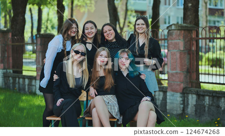 Seven happy students posing together in the schoolyard during a break on a sunny school day Seven happy students posing together in the schoolyard during a break on a sunny school day 124674268