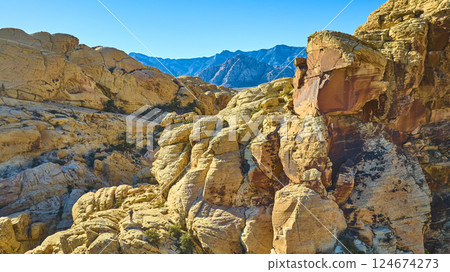 Aerial of Red Rock Canyon Sandstone Formations with Mountain Silhouette 124674273