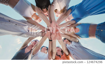 School friends forming a circle, joining hands together, symbolizing unity, teamwork, and the power of collaboration School friends forming a circle, joining hands together, symbolizing unity, teamwork, and the power of collaboration 124674296