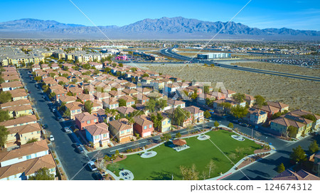 Aerial Suburban Desert Oasis Near Las Vegas with Mountain Backdrop 124674312
