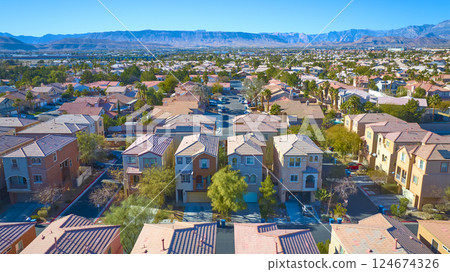 Aerial of Suburban Las Vegas Neighborhood with Mountain Backdrop 124674326
