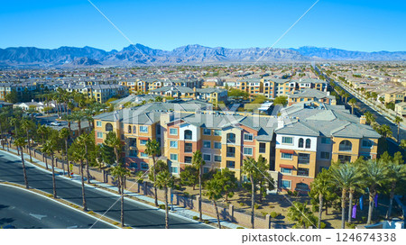 Aerial of Mediterranean Apartments and Mountain Backdrop 124674338