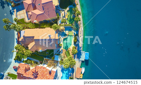 Aerial Top Down of Luxury Waterfront Homes with Pools and Palm Trees 124674515