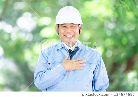 Man in work clothes, park, helmet Man in work clothes, park, helmet 124674695