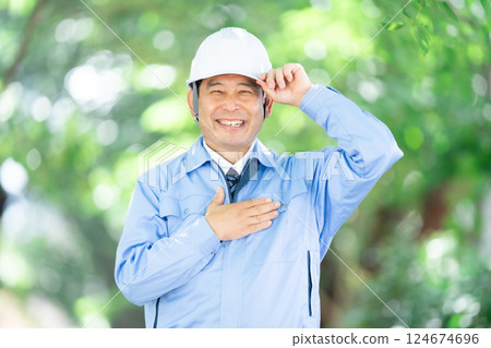 Man in work clothes, park, helmet 124674696