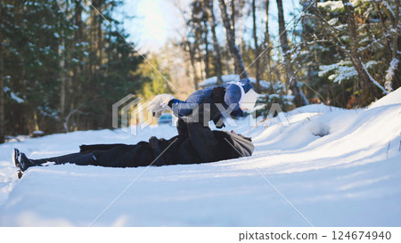 Mother and baby having fun in a snowy forest on a beautiful winter day, enjoying precious family time Mother and baby having fun in a snowy forest on a beautiful winter day, enjoying precious family time 124674940