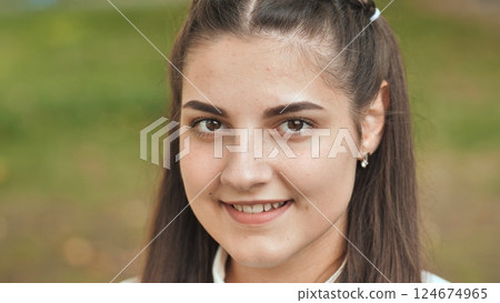 Portrait of a smiling 16 year old girl. Face close up. Portrait of a smiling 16 year old girl. Face close up. 124674965