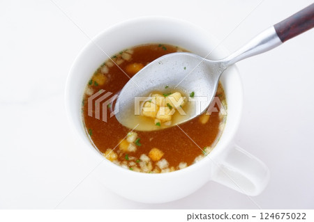 Hot onion consommé soup Hot onion consommé soup 124675022