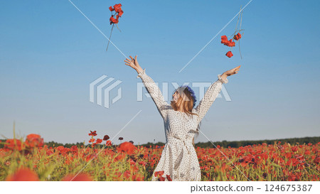 Cheerful female scattering bright red poppy blossoms across sunlit wildflower meadow, embodying summer's radiant spirit Cheerful female scattering bright red poppy blossoms across sunlit wildflower meadow, embodying summer's radiant spirit 124675387