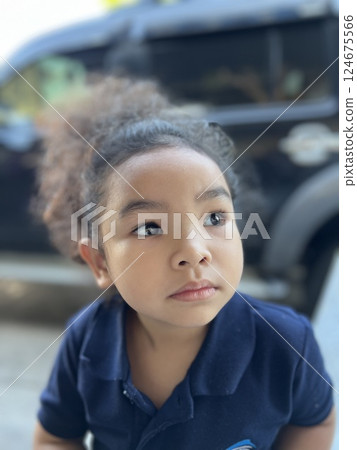 Portrait of a cute little Asian girl looking away 124675566