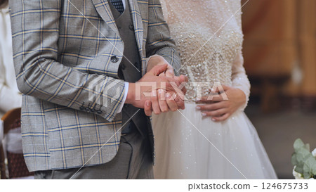 Loving couple holding hands, exchanging wedding vows, representing romantic commitment Loving couple holding hands, exchanging wedding vows, representing romantic commitment 124675733