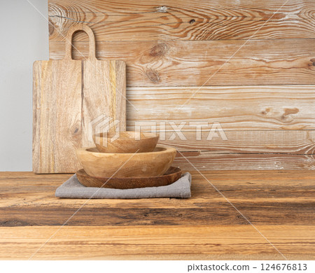 Empty wood bowl on table, plate on wooden table and tablecloth, light rustic dish mockup Empty wood bowl on table, plate on wooden table and tablecloth, light rustic dish mockup 124676813