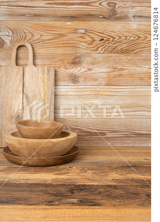 Empty wood bowl on table, plate stack on wooden table, light rustic dish mockup fabric, eco bio 124676814