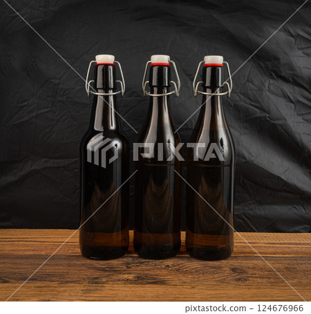 Old beer bottle, brown glass vintage beerbottle, a quality traditional time-tested drink symbol Old beer bottle, brown glass vintage beerbottle, a quality traditional time-tested drink symbol 124676966