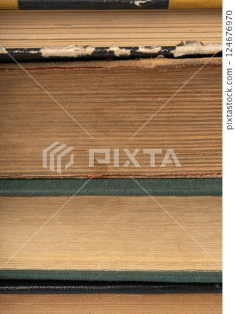 Old book stack pages texture. Vintage books background, antique library collection closeup Old book stack pages texture. Vintage books background, antique library collection closeup 124676970