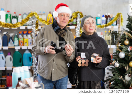 Husband and wife choosing perfume in the supermarket for Christmas 124677169