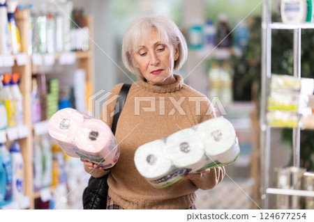 Woman choosing a set of toilet paper 124677254