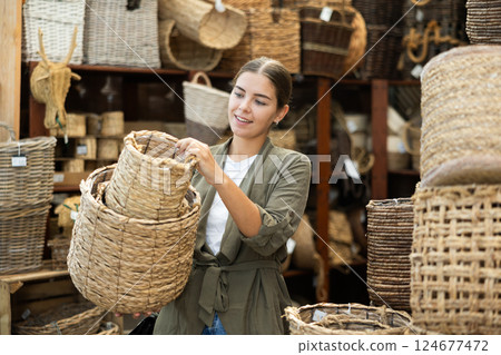 Young woman choosing basket in store 124677472