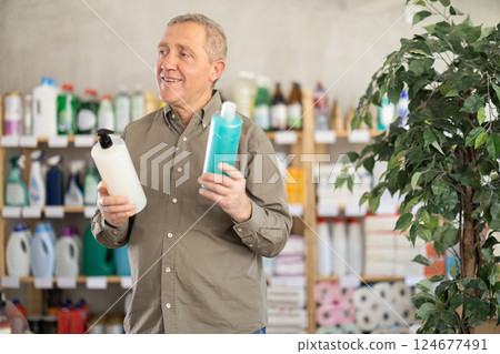 Elderly man choosing shampoo and shower gel 124677491