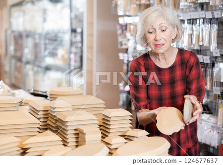 Buying wooden molds for clay products in pottery shop 124677637