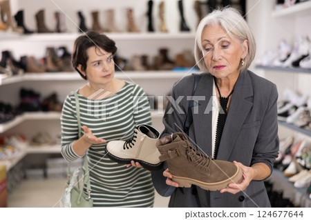 Two women are shopping in shoe store 124677644