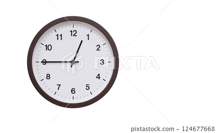 A simple round wall clock with a dark brown frame and a white face displaying 00:45/12:45. Isolated on a white background, perfect for time-related concepts, deadlines, and schedule themes. 124677668
