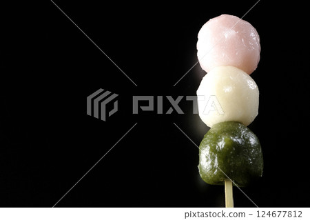 Three-color dumplings photographed against a black background 124677812
