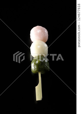 Three-color dumplings photographed against a black background 124677818