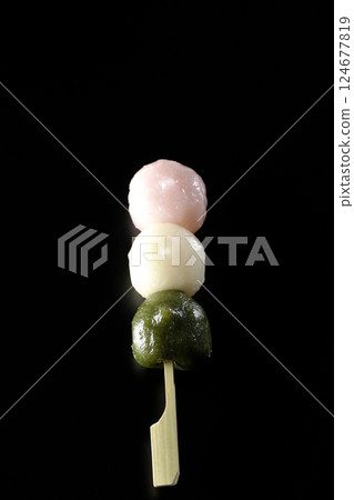 Three-color dumplings photographed against a black background 124677819