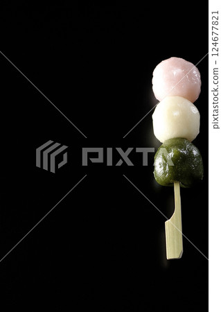 Three-color dumplings photographed against a black background 124677821