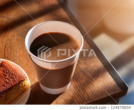 Paper cup of coffee and cake on wooden table 124678604