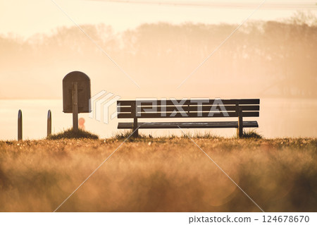 Bench at bathing area at lake in the morning Bench at bathing area at lake in the morning 124678670
