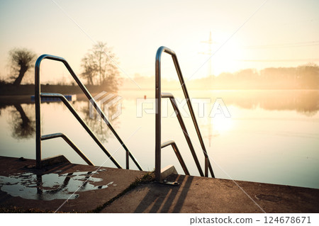 Sunrise over bathing area at lake Sunrise over bathing area at lake 124678671