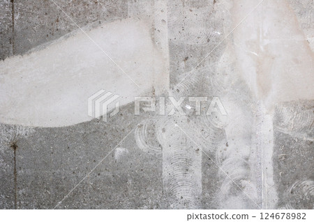 Close up of a concrete wall with a noticeable white stain 124678982