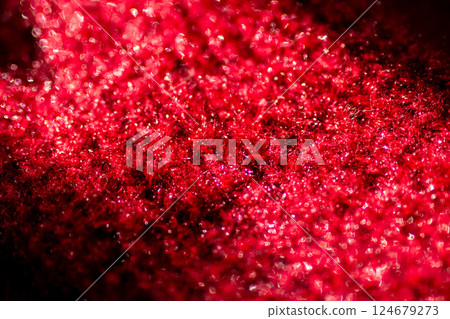 An intricate closeup of vibrant red glitter on a deep black background An intricate closeup of vibrant red glitter on a deep black background 124679273