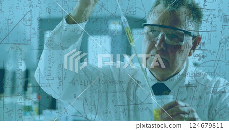 Scientist working in lab with mathematical equations image overlaid 124679811
