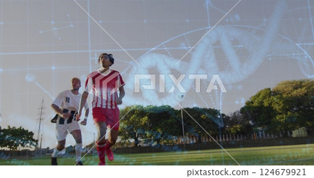 DNA strand and scientific data image over soccer players on field 124679921