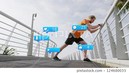 Stretching on bridge, man with social media notifications image overlaid 124680033