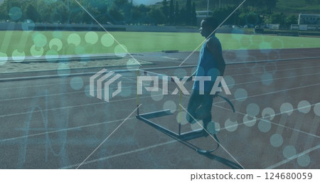 Athlete with prosthetic leg on track with data processing image over scene Athlete with prosthetic leg on track with data processing image over scene 124680059