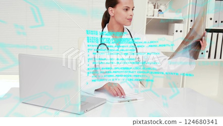 Image of blue data processing over biracial female doctor working at desk with x ray and laptop 124680341