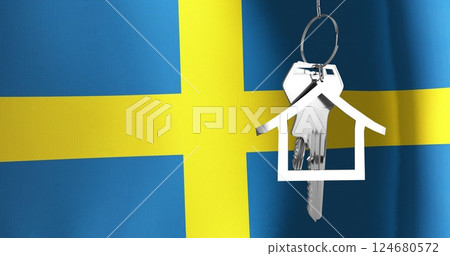 Image of silver house key over waving flag of sweden 124680572