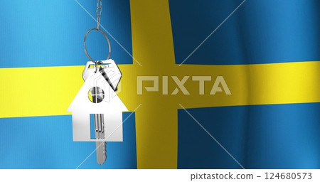 Image of silver house key over waving flag of sweden 124680573