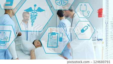 Image of medical icons over diverse doctors using defibrillator on patient Image of medical icons over diverse doctors using defibrillator on patient 124680791