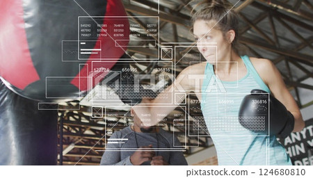 Image of digital data processing over biracial woman boxing with male instructor Image of digital data processing over biracial woman boxing with male instructor 124680810
