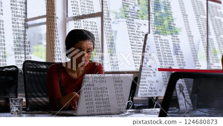 Image of financial data processing over biracial businesswoman using laptop in office 124680873