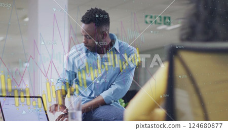 Image of diagram and data processing over biracial colleagues using laptop in office 124680877