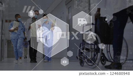 Image of heartbeat and medical icons over diverse doctors in face masks talking in corridor 124680948