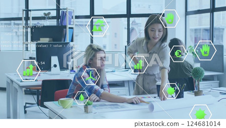 Image of data processing and ecology icons over diverse colleagues discussing work in office 124681014