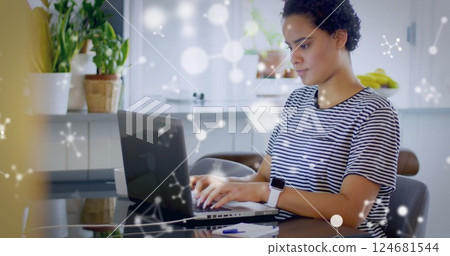 Image of molecules over biracial woman using laptop 124681544