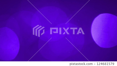 Image of glowing light spots moving over purple background 124681579